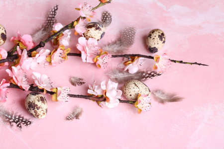 easter still life flowers and eggs on a pink background
