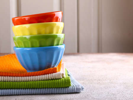 colored bowls utensils and napkins for foodの写真素材