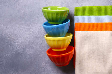 colored bowls utensils and napkins for foodの写真素材