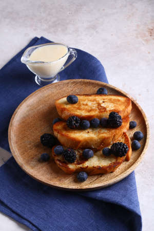 fried croutons with fresh berries for breakfastの写真素材