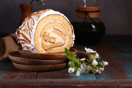 biscuit roll with creamy cream with meringue for dessert