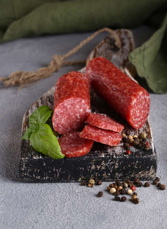 natural organic salami sausage with pepper on a wooden boardの写真素材