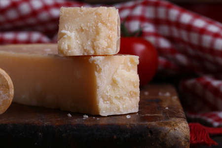 italian hard parmesan cheese on a wooden tableの写真素材