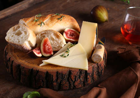 cheese plate with figs, baguette and wine