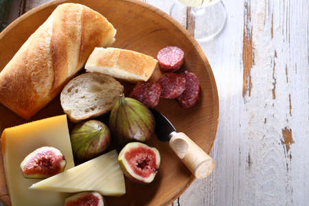 cheese plate with figs, baguette and wine