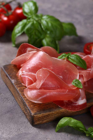 fresh prosciutto ham on a wooden board