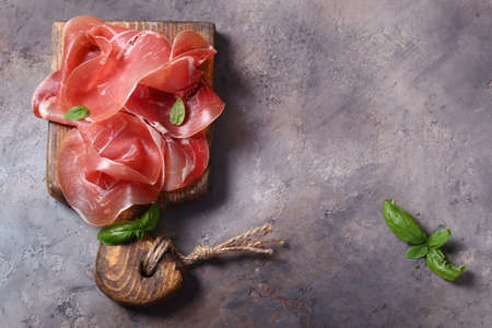 fresh prosciutto ham on a wooden board