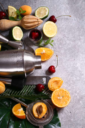 cocktail shaker and fruits on a gray backgroundの写真素材