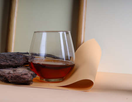 glass with brandy whiskey on natural background