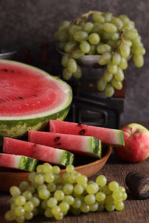 autumn harvest fruit watermelon grapes and applesの写真素材