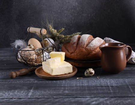 rustic still life with bread and butter on a wooden background