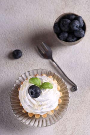 mini cake basket with meringue creamの写真素材