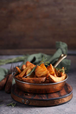 potato wedges with rosemary fried in a pan