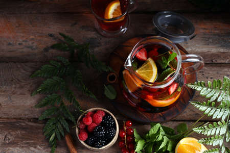 fruit berry tea in a glass teapotの写真素材