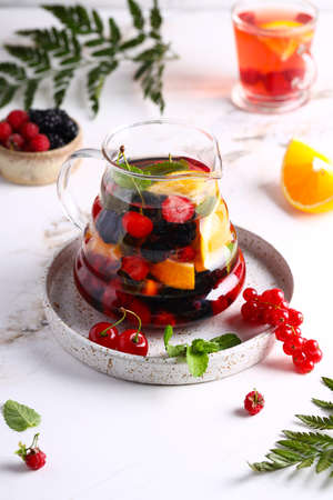 fruit berry tea in a glass teapotの写真素材