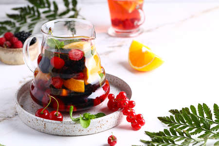 fruit berry tea in a glass teapotの写真素材