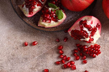 ripe organic pomegranate fruit on the tableの写真素材