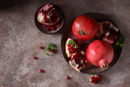 ripe organic pomegranate fruit on the tableの写真素材