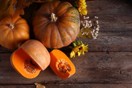 ripe organic pumpkin on wooden tableの写真素材