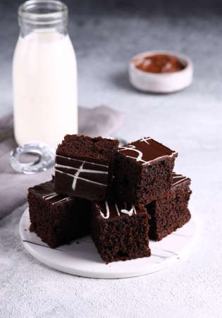 chocolate brownie cake with ganache on a plate