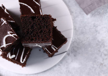 chocolate brownie cake with ganache on a plate