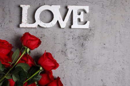 bouquet of festive flowers roses and gift box for backgroundの写真素材