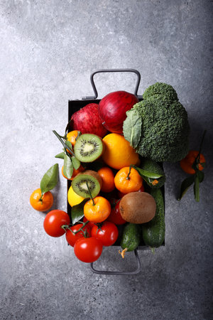 fresh organic fruits and vegetables in a boxの写真素材