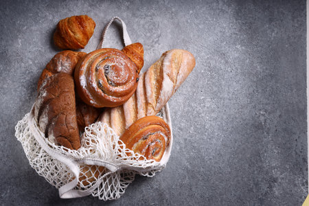 assortment of bread in a string bagの写真素材