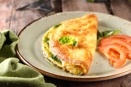 breakfast with fried eggs and toast on a plateの写真素材