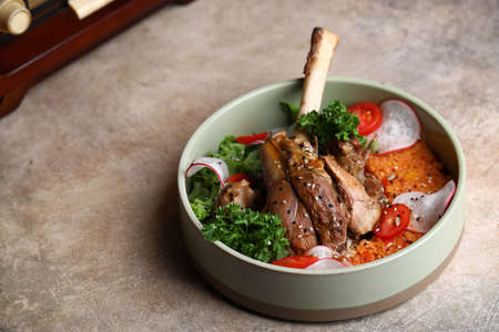 meat knuckle with vegetables in a bowlの写真素材