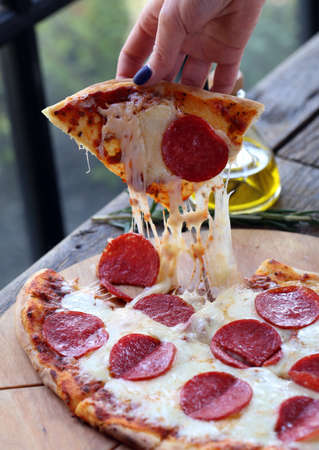 traditional pizza with cheese and tomatoes