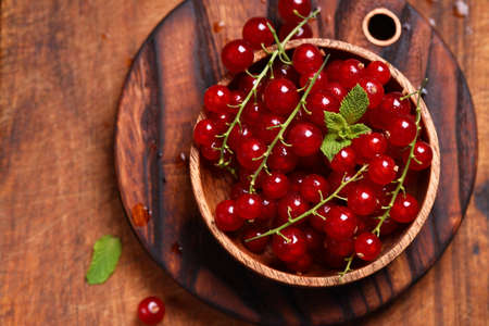 fresh red berry currant on wooden backgroundの写真素材