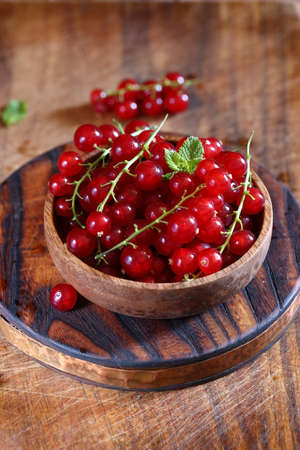 fresh red berry currant on wooden background