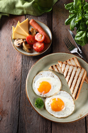 breakfast with eggs and toast on a wooden tableの写真素材