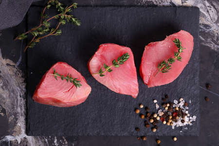raw fresh tuna steaks on black backgroundの写真素材