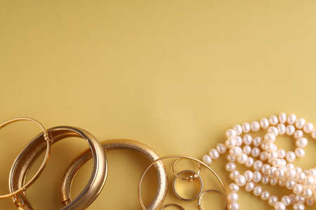 gold jewelry, rings on a yellow background