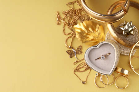 gold jewelry, rings on a yellow background