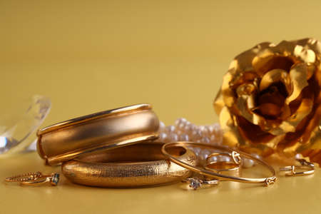 gold jewelry, rings on a yellow backgroundの写真素材