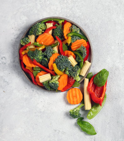 fresh vegetable mix in gray plate on light gray background top viewの写真素材