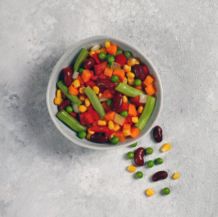 fresh vegetable mix in gray plate on light gray background top viewの写真素材