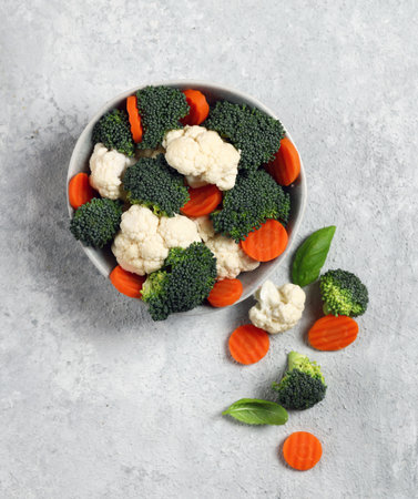 fresh vegetable mix in gray plate on light gray background top viewの写真素材