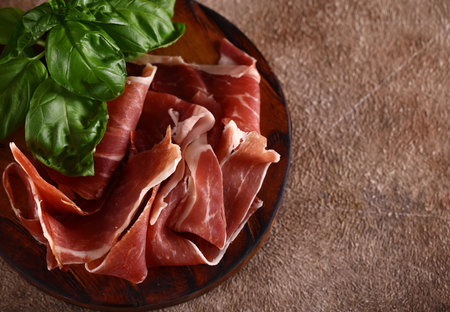 organic parma ham dry cured jamon on a wooden boardの写真素材
