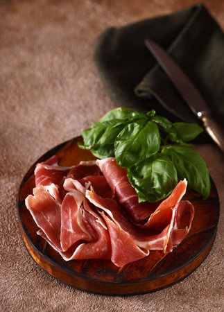 organic parma ham dry cured jamon on a wooden boardの写真素材