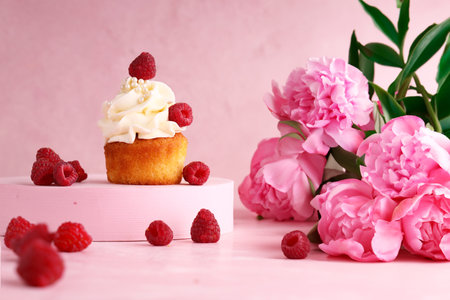 feminine pink still life with cupcake and flowersの写真素材