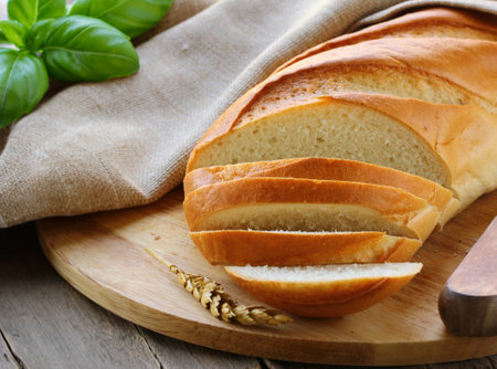white loaf of bread sliced on a boardの写真素材