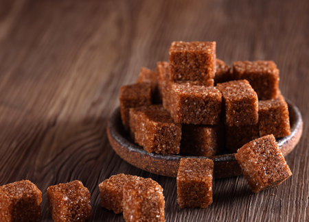 natural brown cane sugar on wooden backgroundの写真素材