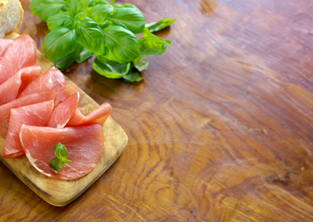 smoked ham of pork on a wooden boardの写真素材