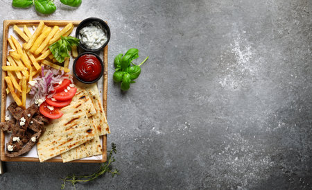 meat dish kebab with potatoes and sauces