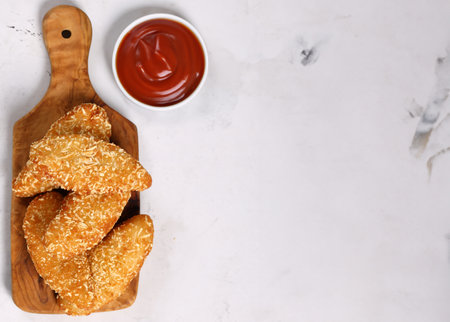 fried chicken nuggets on a wooden board