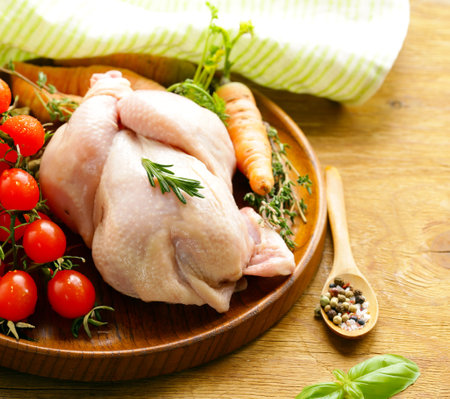 raw chicken meat with herbs and spicesの写真素材